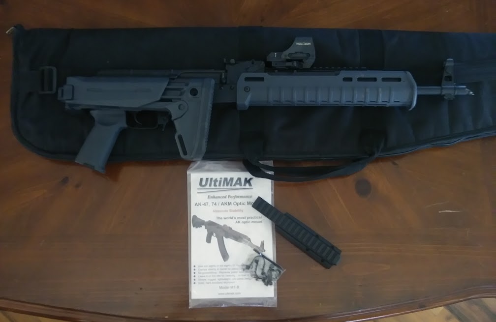 Ultimak and AK rifle.jpg
